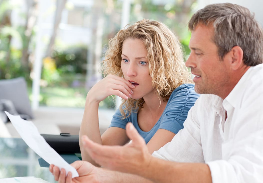 Shocked couple look at tax levy notice